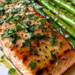 20-Minute garlic butter salmon served on a plate with herbs and lemon