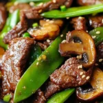 Asian beef stir-fry with mushrooms and snow peas served in a bowl