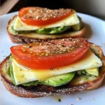 Avocado mozzarella and tomato grilled cheese sandwich on a plate