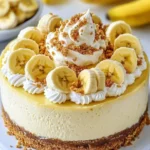 Delicious banana pudding cheesecake topped with fresh bananas and whipped cream