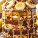 Slice of Banana Walnut Fudge Cake with walnuts and chocolate fudge icing