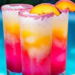 Glass of Beach Peach Lemonade with slices of peach and lemon