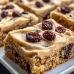 Brown butter oatmeal raisin cookie bars with raisins and oats on a wooden table
