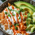 Buffalo Chicken Cottage Cheese Bowl topped with celery and ranch dressing