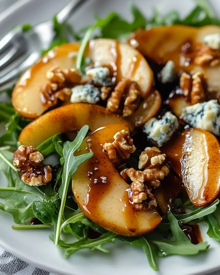 Caramelized Pear and Blue Cheese Salad topped with nuts and greens