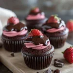 Chocolate strawberry cupcakes topped with fresh strawberries and chocolate frosting