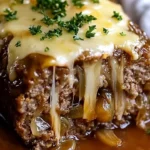 Crockpot French Onion Meatloaf topped with melted Swiss cheese