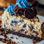Delicious Cookie Monster Cheesecake topped with cookie crumbles and blue frosting.