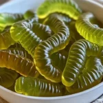 Dill pickle gummy worms in a colorful display