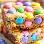 Colorful Easter Cake Mix Cookie Bars topped with sprinkles on a white platter