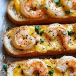 Garlicky shrimp ciabatta sandwich topped with melted cheddar jack cheese
