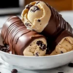Bowl of homemade coffee ice cream topped with chocolate shavings and coffee beans