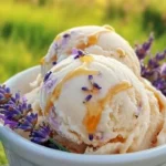Creamy Honey Lavender Ice Cream in a cone, topped with lavender flowers