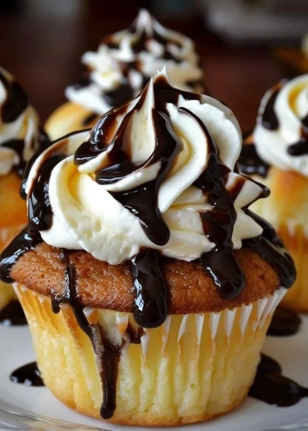 Delicious Boston Cream Pie Cupcakes topped with creamy frosting and chocolate glaze