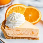 Delicious Jello Creamsicle Pie topped with whipped cream and orange slices