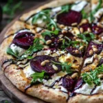 Lemon and roasted beet ricotta pizza topped with fresh herbs