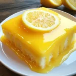 Lemon Sunshine Glaze Cake topped with a glossy lemon glaze and lemon slices.