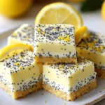 Low sugar lemon poppy seed Greek yogurt bars on a plate.