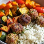 Delicious meatballs served with roasted vegetables and rice on a plate