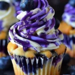 No-bake blueberry vanilla cheesecake cupcakes served in elegant cupcake liners.