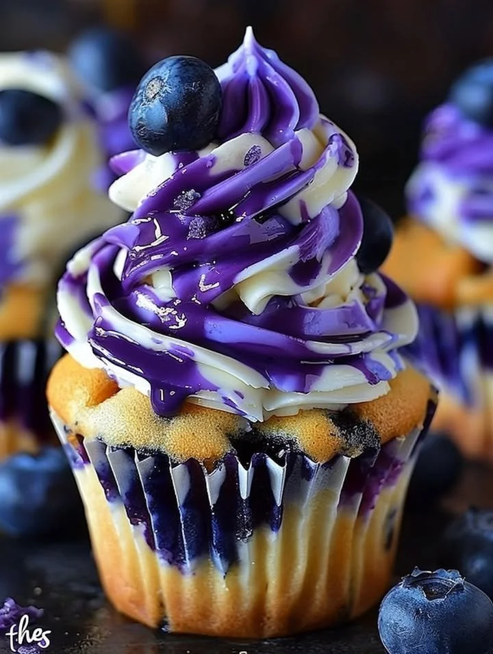 No-bake blueberry vanilla cheesecake cupcakes served in elegant cupcake liners.