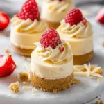 No-bake white chocolate cheesecake bites on a platter with graham cracker crust.