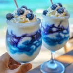 Tropical Ocean Love Colada cocktail with coconut and pineapple garnishes