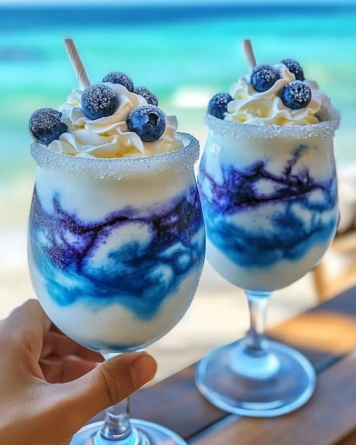 Tropical Ocean Love Colada cocktail with coconut and pineapple garnishes