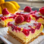 Delicious Raspberry Lemon Cheesecake Bars decorated with fresh raspberries