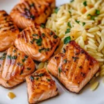 Delicious salmon bites served with lemon butter orzo dish