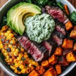Steak, avocado, and roasted corn bowl drizzled with cilantro cream sauce