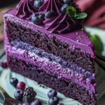 Delicious slice of ultimate purple velvet cake topped with cream cheese frosting